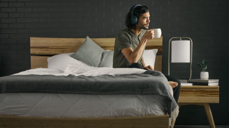a man on the mattress listening to music