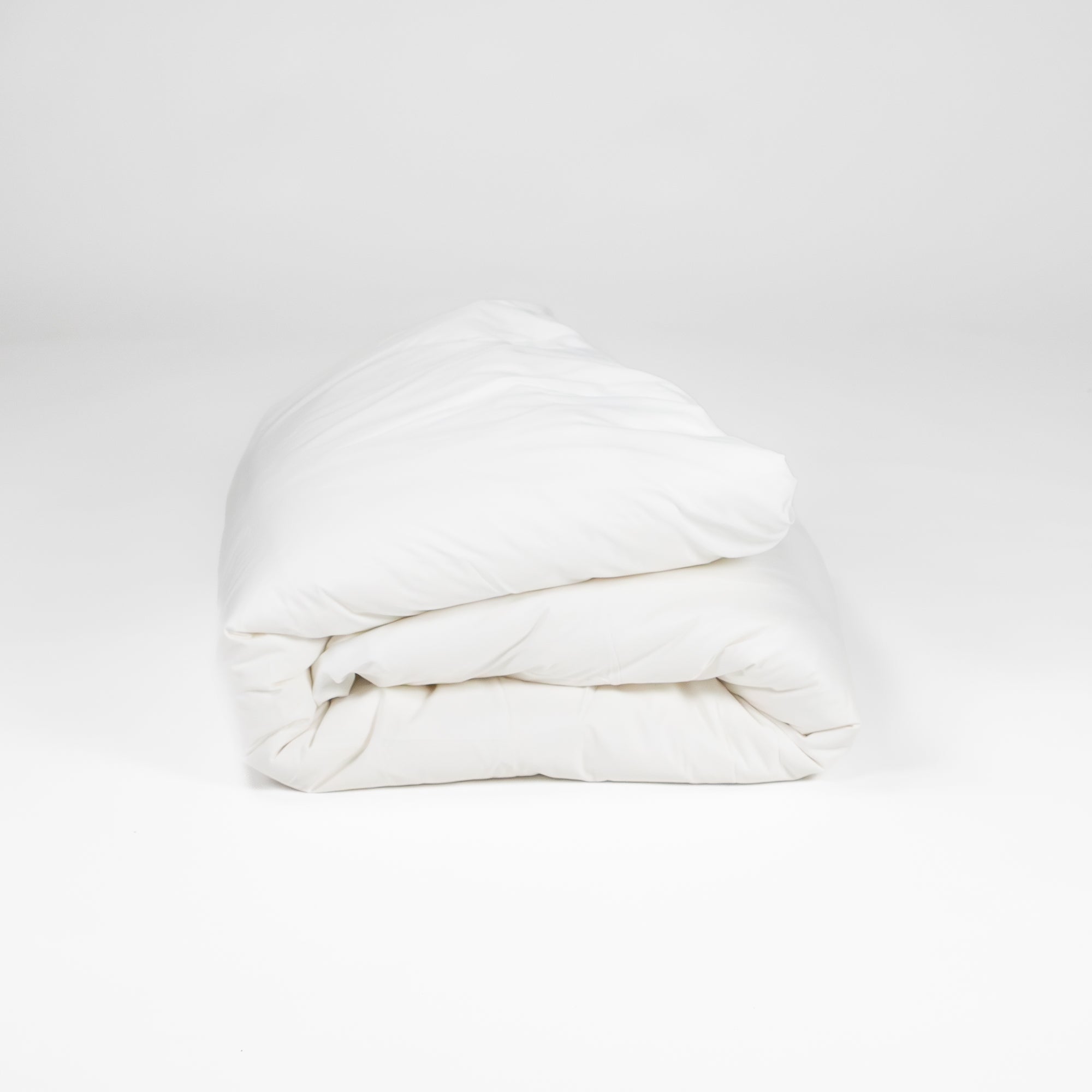 Organic cotton duvet cover folded up in white