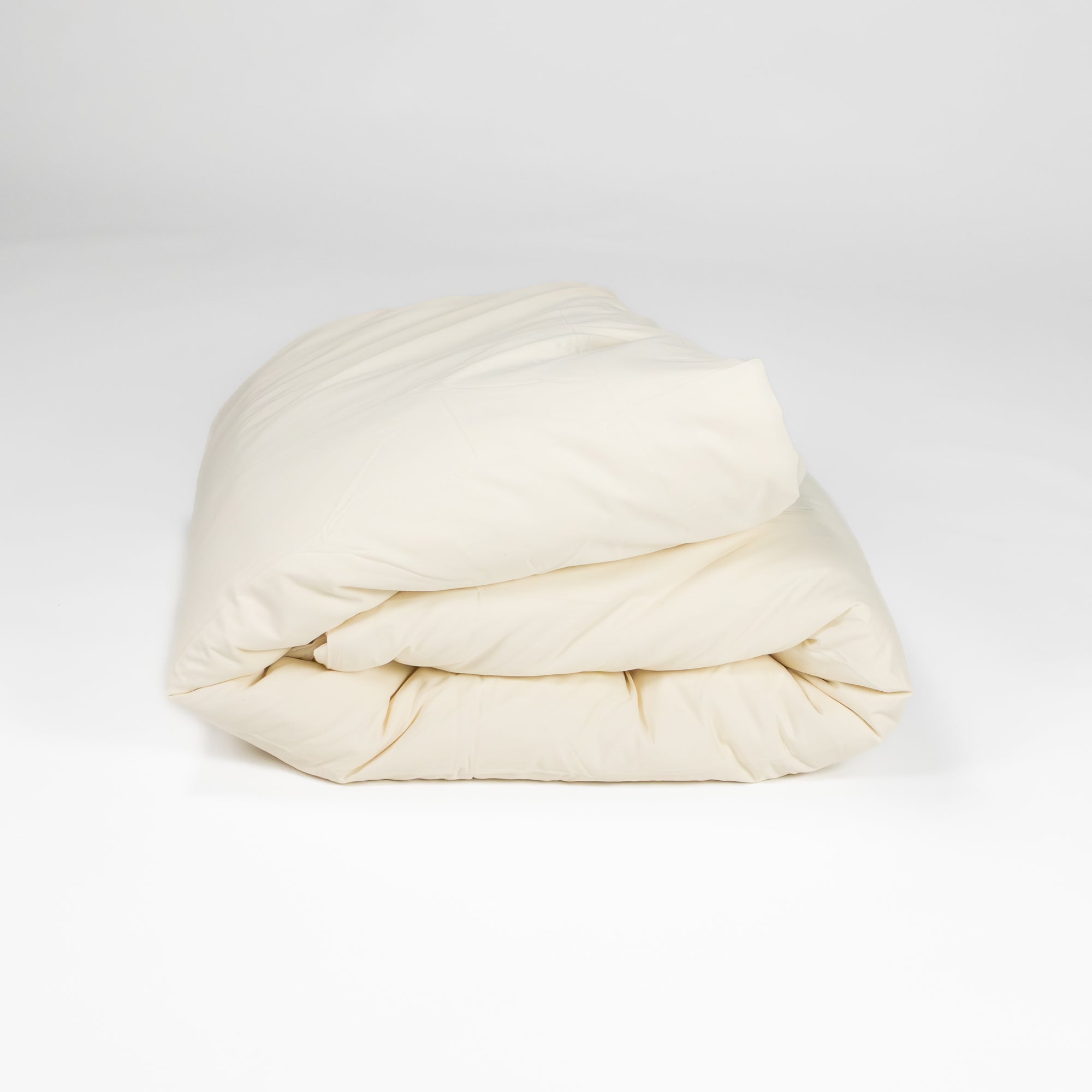 Organic cotton duvet cover folded up in natural