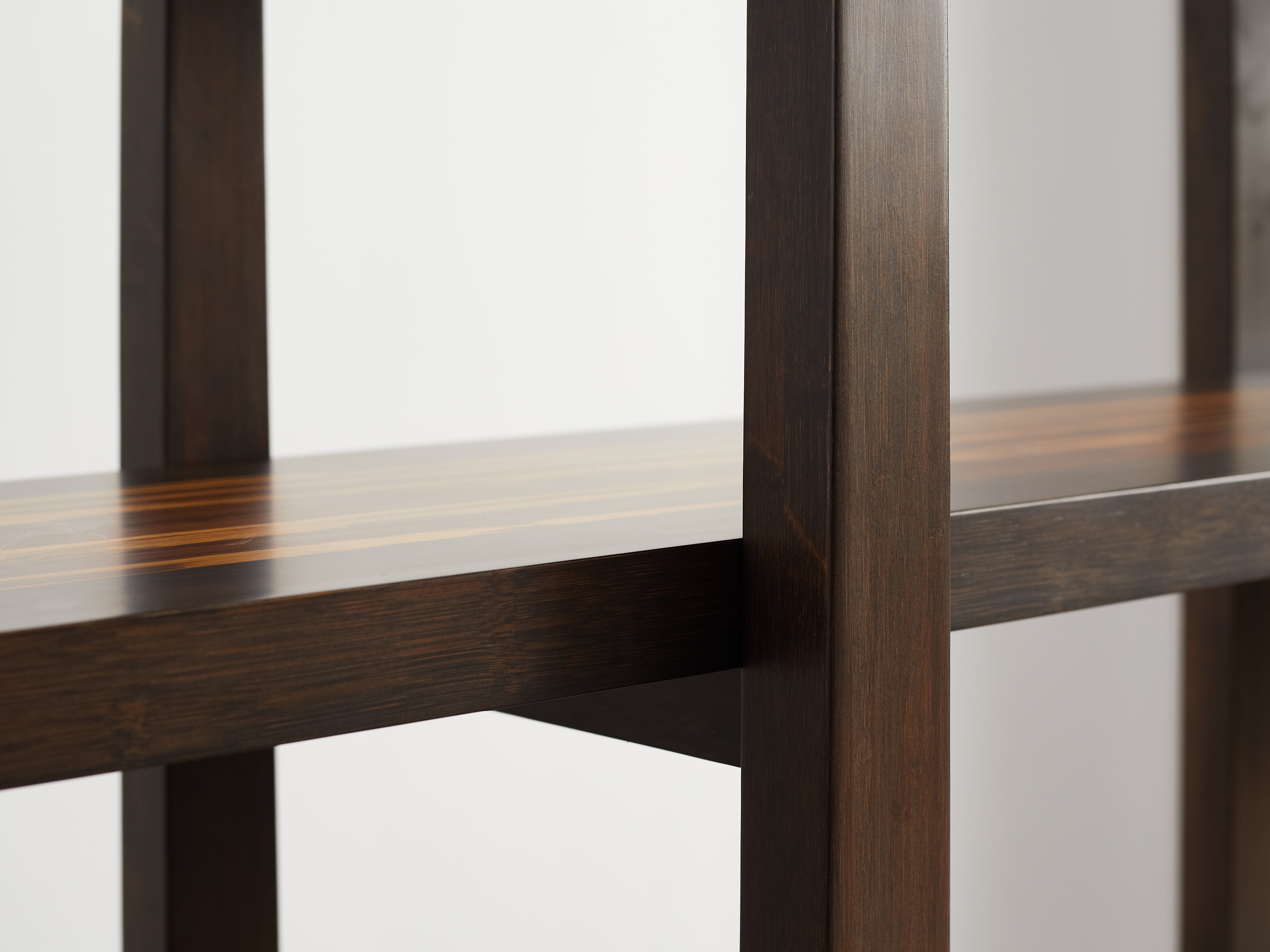 Wooden shelf with a dark brown finish on a white background