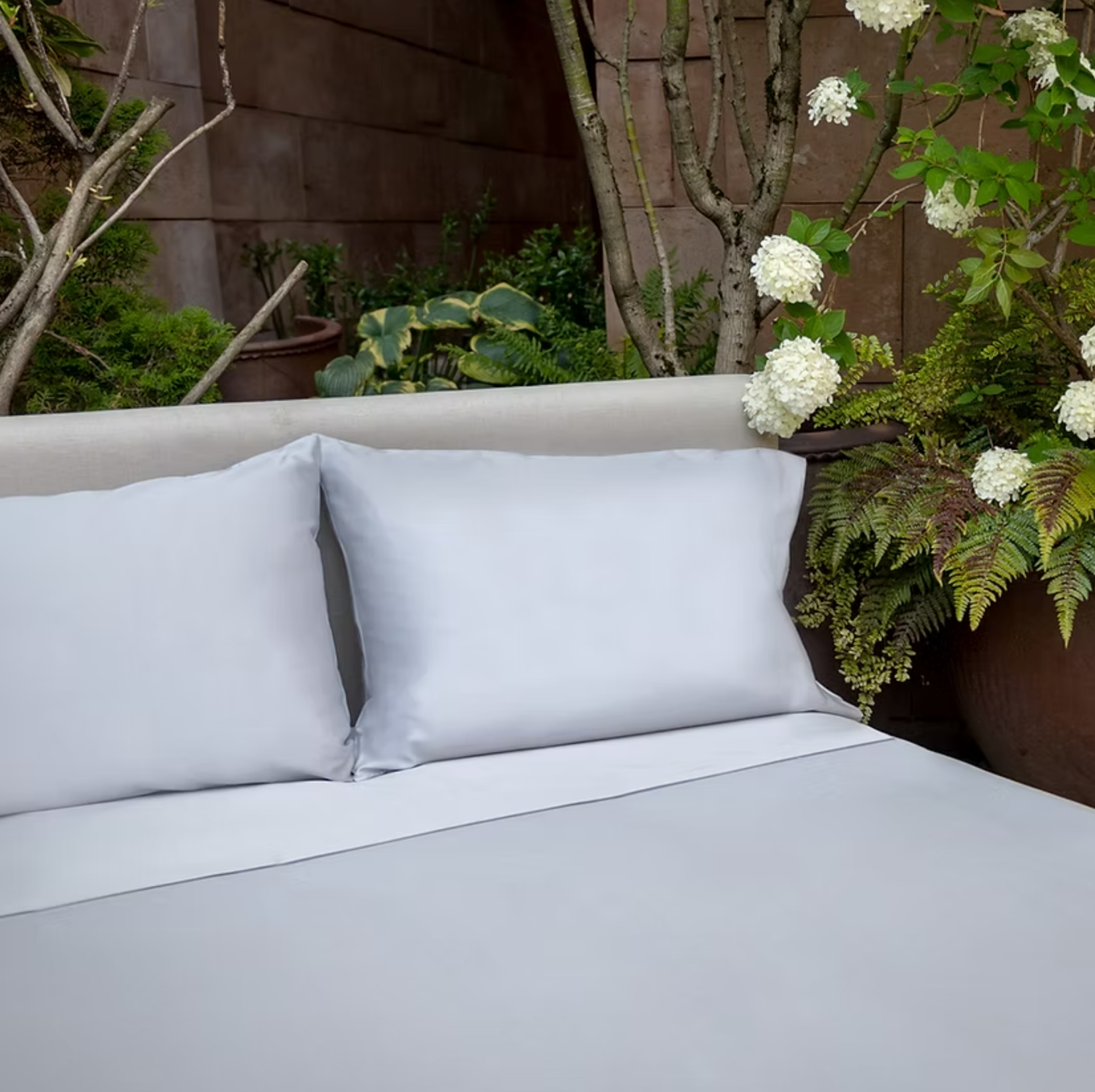 Porto Cotton Sateen Sheet Set grey on bed with headboard